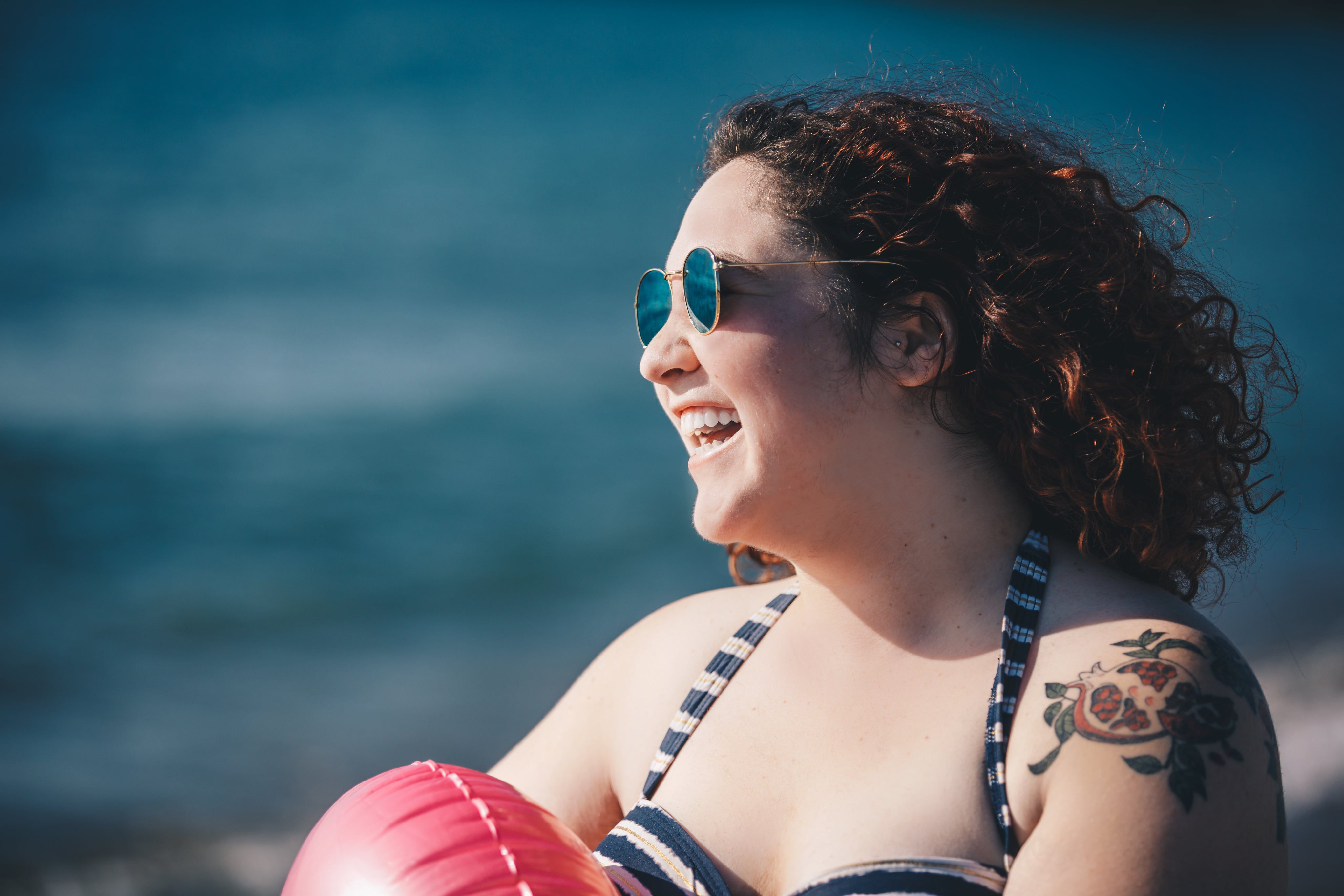 files/young-woman-in-swimwear-and-sunglasses-on-sunny-beach.jpg